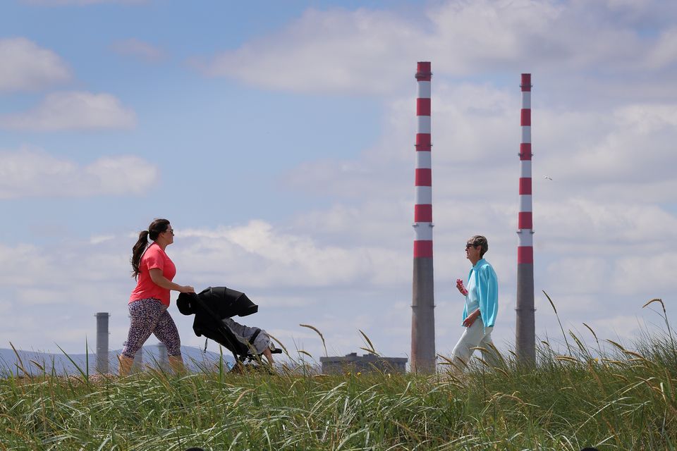 Walkers in the  sunshine on the Bull Wall, Clontarf. Photo: Frank McGrath